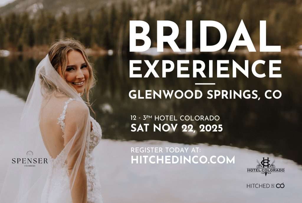Bride smiling over her shoulder in front of a mountain lake promoting the Glenwood Springs Bridal Experience at Hotel Colorado.